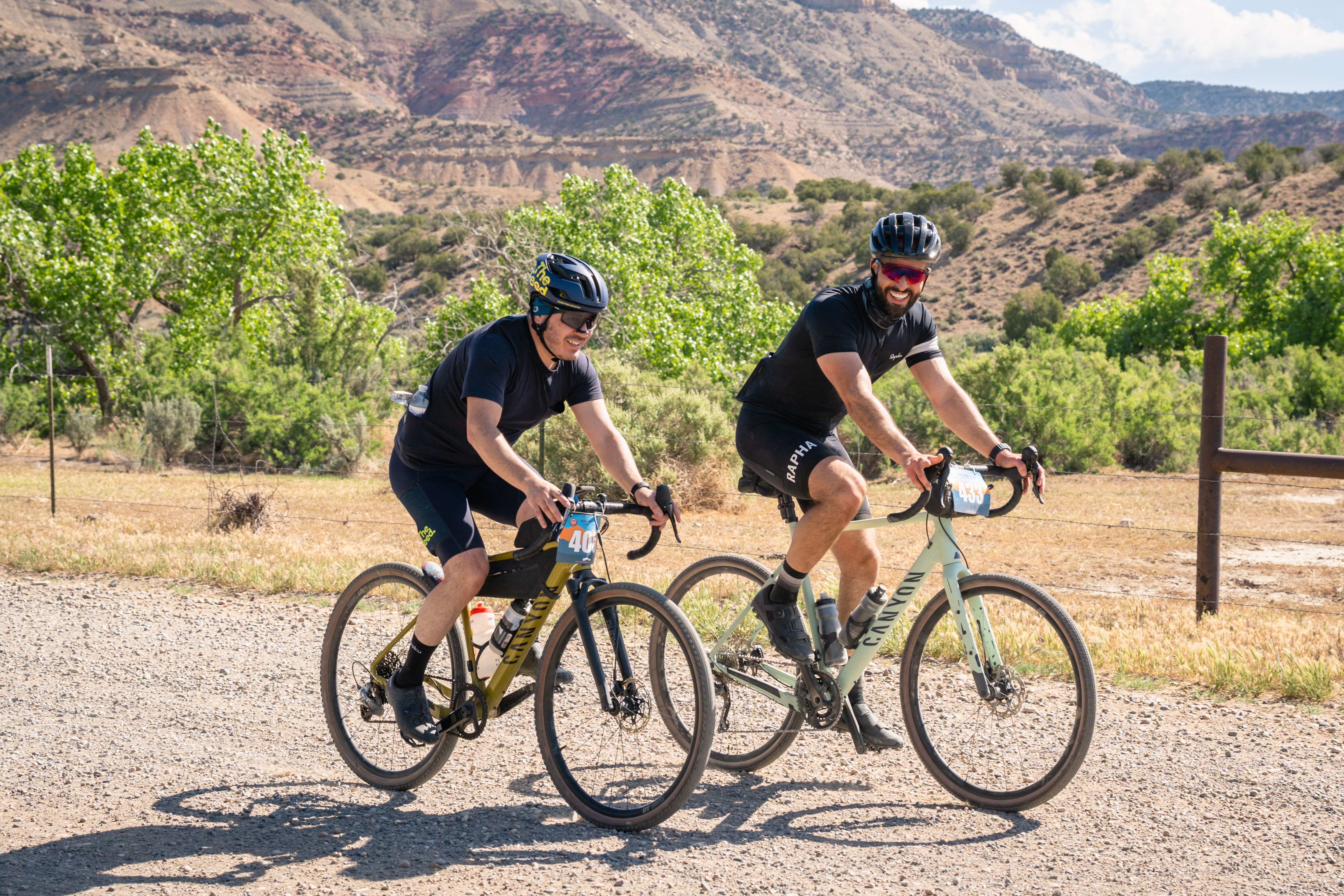 Two cyclists riding a gravel race through the Colorado high desert
